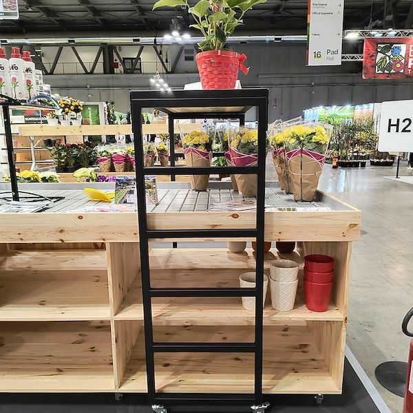 Elevated bridge shelf in natural wood with black painted iron frame